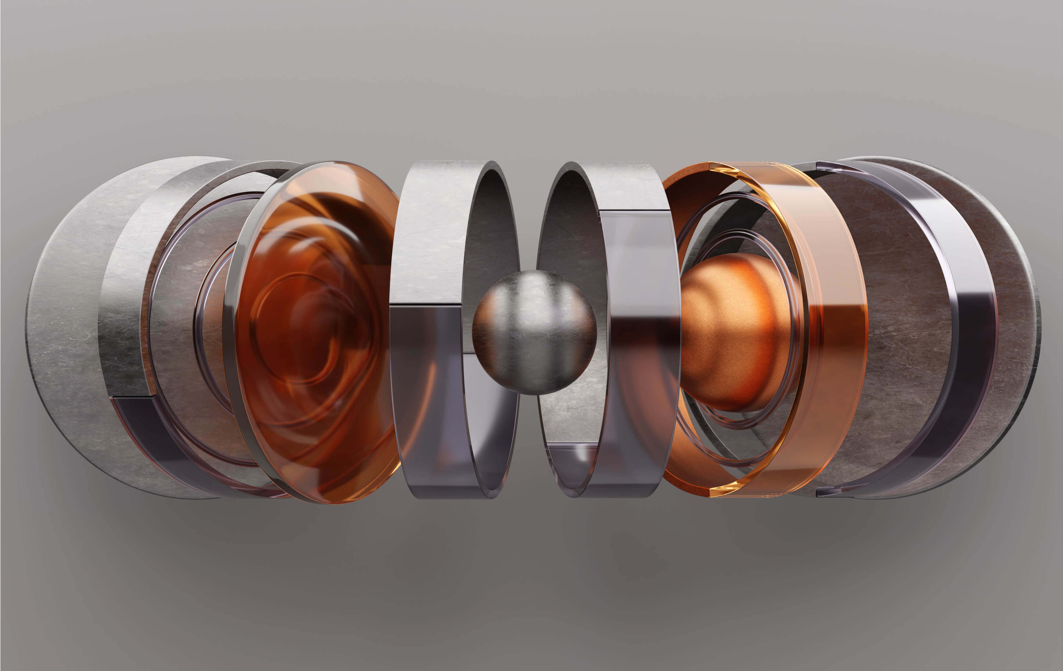 A crafted metal and copper ring resting on a gray surface, showcasing its unique features and elegant design