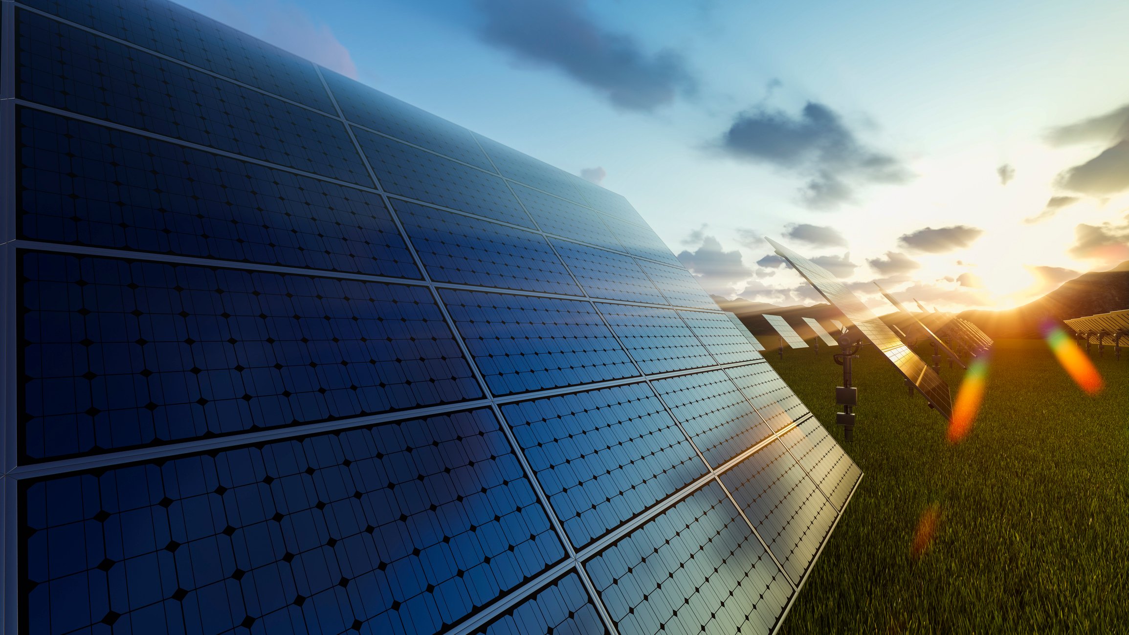 sun striking on solar panels in a field